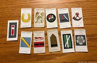Fronts of all 11 cards showing insignia designs