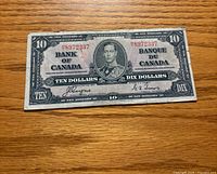 Obverse showing portrait, serial number 8972837, denomination, bilingual text