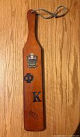 Front view showing crest, Greek letters Φ Κ and Beta Chapter text