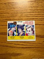 Front of 1980-81 O-Pee-Chee Assist Leaders card showing Gretzky, Dionne, Lafleur