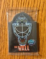 Front of sealed goalie mask-shaped package showing The Wall graphic and Collector's Edge Ice logo