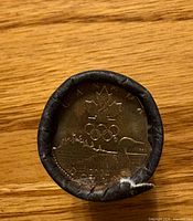 End view of roll showing 2004 Lucky Loonie coin design