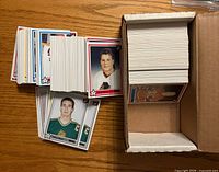 Stack and box of 1990-91 WHL hockey cards spread on table