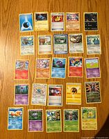 Front view of 25 Pokémon cards showing faces, including Water Energy, Great Ball, Lightning Energy and assorted Pokémon.