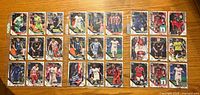 Fronts of 27 Topps soccer cards laid out in three rows