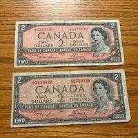 Fronts of two 1954 Canadian $2 notes showing serial numbers, portrait and signatures