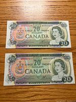 Front of both 1969 $20 banknotes showing serial numbers and portrait