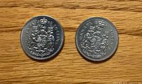 Both 1969 Canada 50 cent coins reverse side showing Coat of Arms