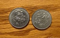 Both coin reverses showing Manitoba prairie crocus design and inscriptions