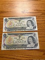 Obverse of both 1973 Canada $1 banknotes showing Queen Elizabeth II and serial numbers