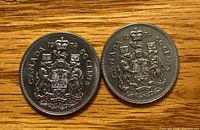 Both 1974 Canadian 50-cent coins reverse side showing coat of arms