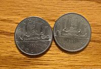 Both coins reverse side showing canoe design and 1980 date