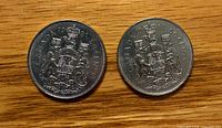 Both 1981 Canadian 50-cent coins shown reverse side with coat of arms