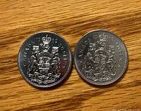Reverse sides showing 1982 date and Canadian Coat of Arms on both coins