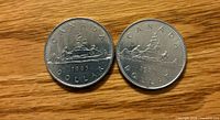Two 1985 Canadian $1 coins reverse side showing Voyageur design
