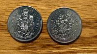 Reverse view showing Canadian Coat of Arms on both 1985 50-cent coins