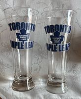 Two clear Toronto Maple Leafs pilsner glasses standing side by side