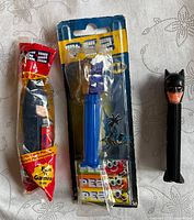 Front view of three Batman Pez dispensers, two sealed, one loose