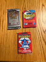 Front view showing three sealed baseball card packs: 1992 Leaf Set Series 1, Donruss Puzzle and Cards, Score Player and Trivia Cards