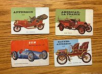 Front view of four World on Wheels cards showing vehicle illustrations and titles