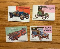Fronts of four Topps 1954 World on Wheels cards showing illustrated vehicles