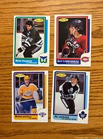 Fronts of four 1986-87 O-Pee-Chee hockey cards laid out