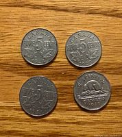Obverse sides of four Canada 5 cent coins showing dates 1922, 1927, 1931, 1949