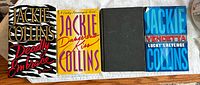 Four Jackie Collins hardcover novels laid out showing front covers