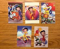 Fronts of five Betty Boop postcards displayed