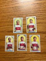 Fronts of five C55 hockey card reprints laid out on wood surface