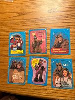Fronts of all six ALF stickers on wood surface