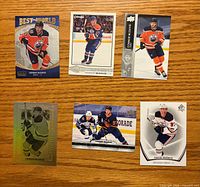 Front view of six Connor McDavid cards showing different designs