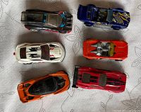 Top view of six Hot Wheels cars showing colours and designs