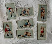 Front view of seven 1925 Player's Cigarettes Wrestling & Ju-Jitsu series cards