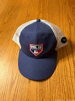 Front view showing MLB Network shield on navy crown and brim