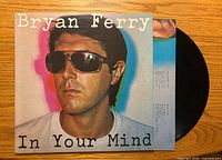 Front cover and partial vinyl showing artist portrait and title