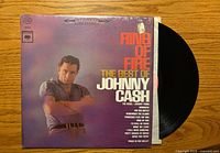 Front cover showing album title and artist, partial view of vinyl record
