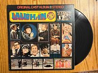 Front of sleeve showing title and cast photos with vinyl partially visible