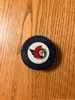 Front of puck showing Ottawa Senators logo