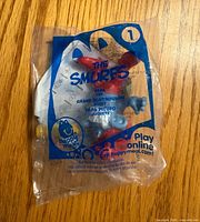 Front of sealed Papa Smurf Happy Meal bag showing graphics and figure