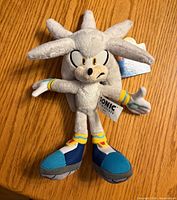 Front view of Silver the Hedgehog plush with hang tag visible