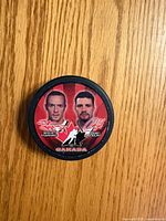 Front of puck showing player portraits and signatures