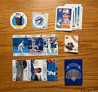 Front view showing all cards, sticker, pin and promotional pack