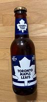 Brown glass bottle with Toronto Maple Leafs label and cap
