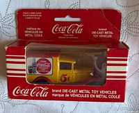 Front of boxed Coca-Cola die-cast truck showing vehicle and packaging details