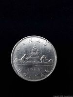 Reverse side showing Voyageur canoe design with date 1968