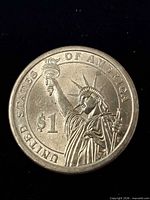 Obverse showing Statue of Liberty design and $1 denomination