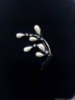 front view of brooch showing pearl buds and rhinestones