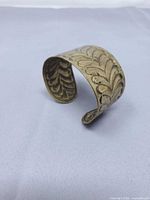 Front angle of brass cuff showing embossed pattern