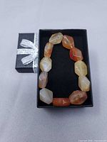 Bracelet inside black gift box showing all beads